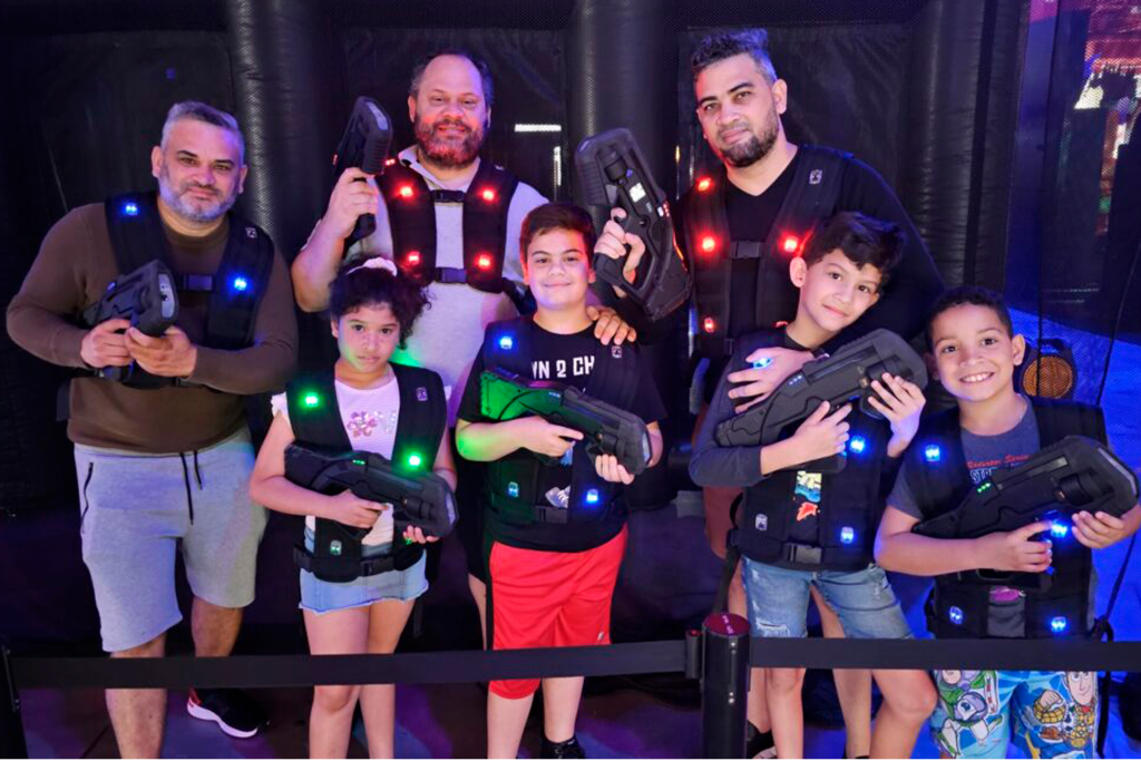 Family posing before playing the fun laser tag maze at Dezerland Park Orlando