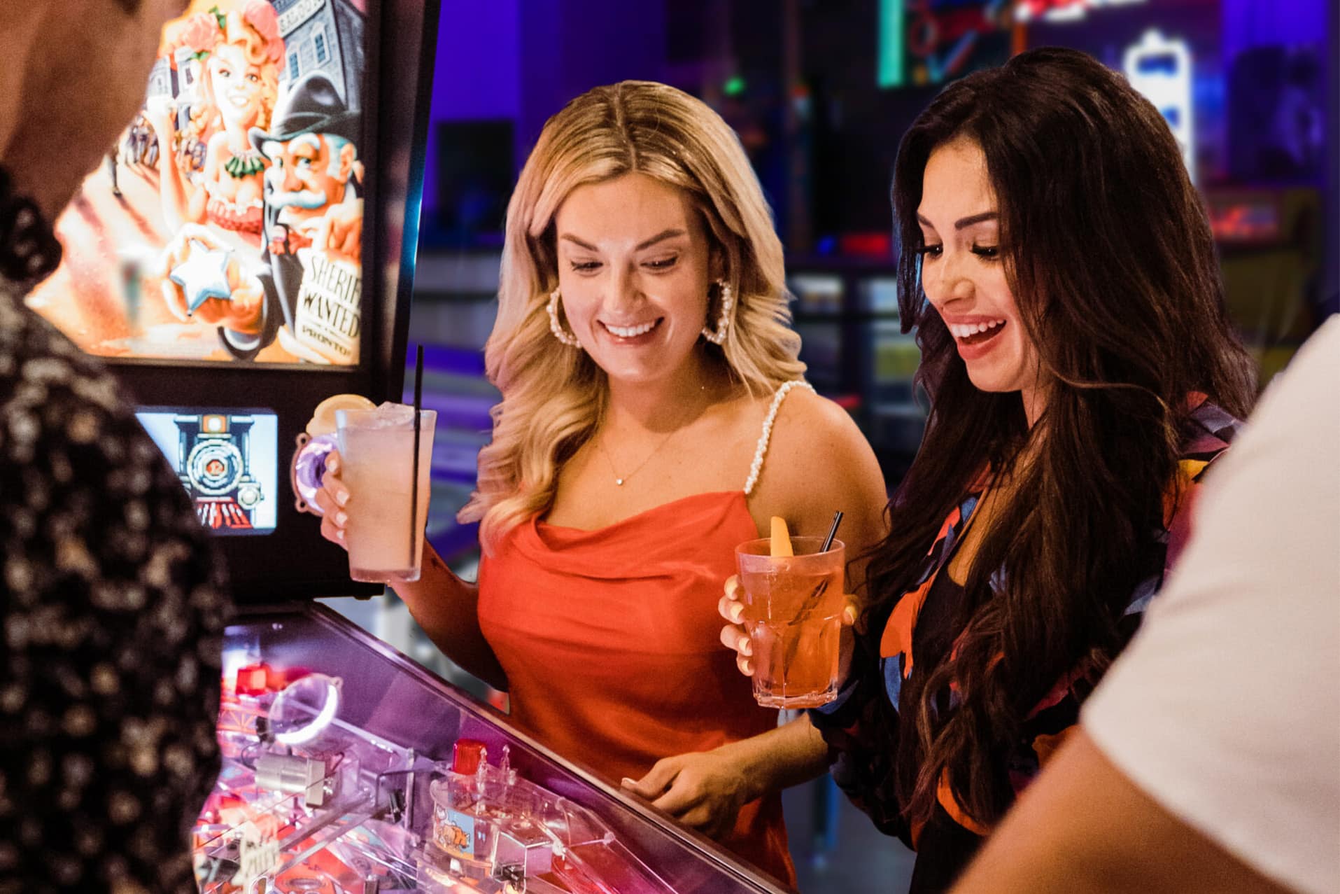 People enjoying drinks inside The Pinball Palace at Dezerland Park